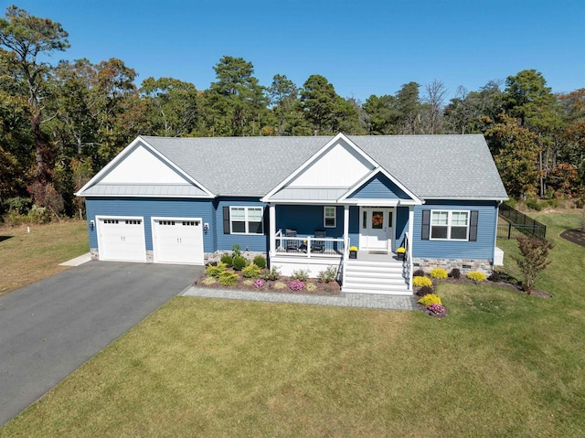 view of front of property with a front lawn, a porch, and a garage