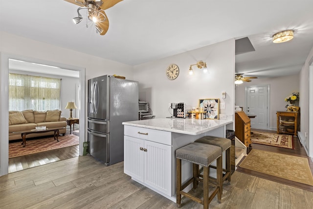 200 Sunray Beach Rd, Del Haven, NJ 08251 - kitchen with freestanding refrigerator, a ceiling fan, light wood-style flooring, and a breakfast bar area