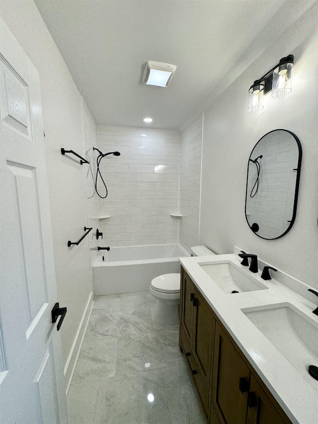 full bathroom featuring tiled shower / bath combo, toilet, and vanity