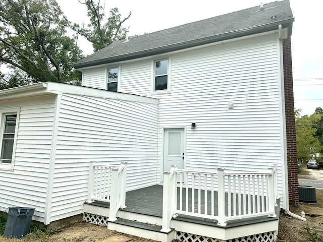 rear view of house featuring central AC and a deck