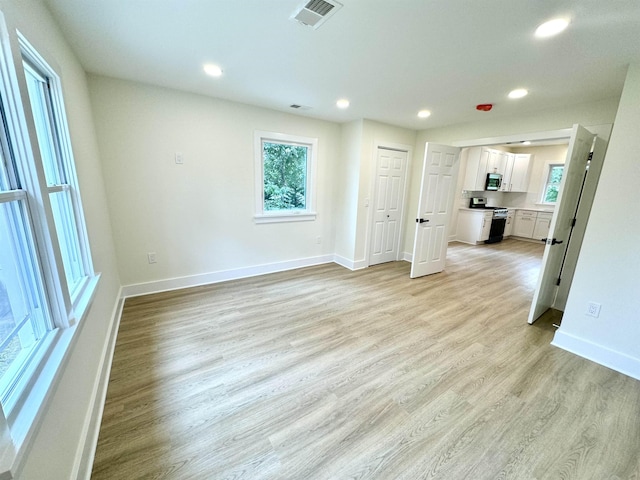 unfurnished living room with light hardwood / wood-style flooring