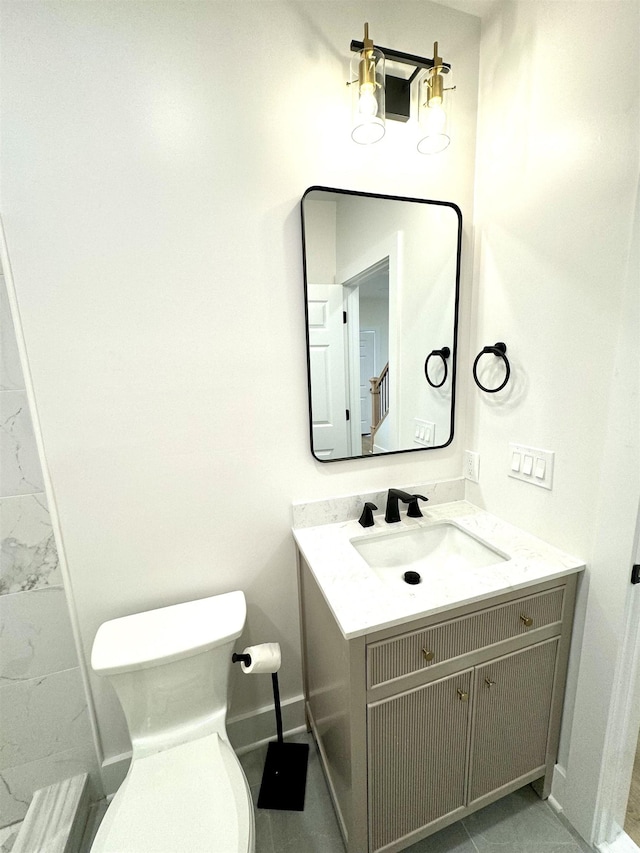 bathroom with tile patterned floors, vanity, and toilet