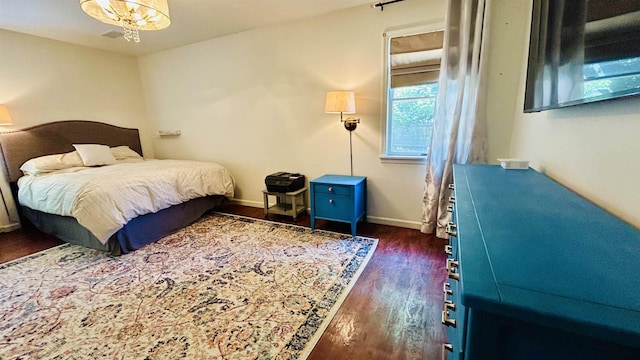 bedroom with dark wood-type flooring