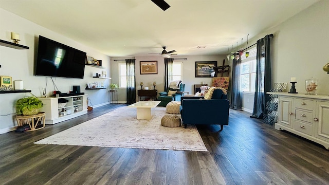 living room featuring ceiling fan, a healthy amount of sunlight, and dark hardwood / wood-style flooring