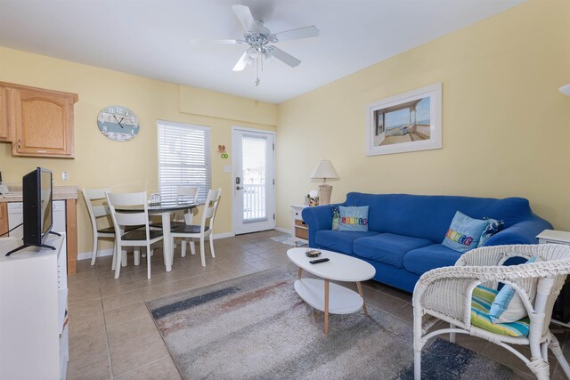 tiled living room with ceiling fan