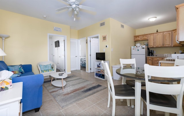 tiled dining area featuring ceiling fan