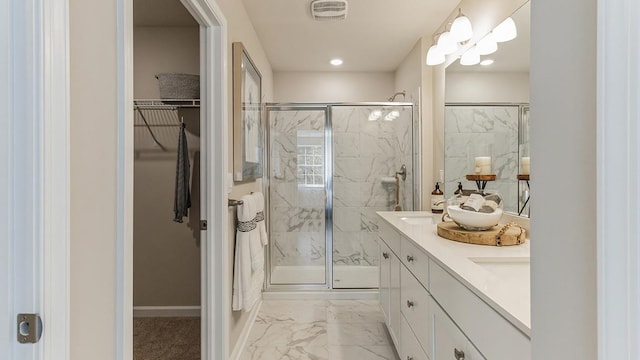 17 N 10th St, Del Haven, NJ 08251 - full bathroom with marble look tiles, a marble finish shower, a spacious closet, double vanity, and baseboards