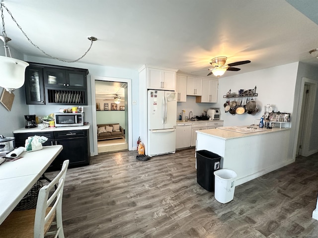 110 S 9th St, Del Haven, NJ 08251 - kitchen featuring white appliances, dark cabinets, light countertops, and dark wood-style floors