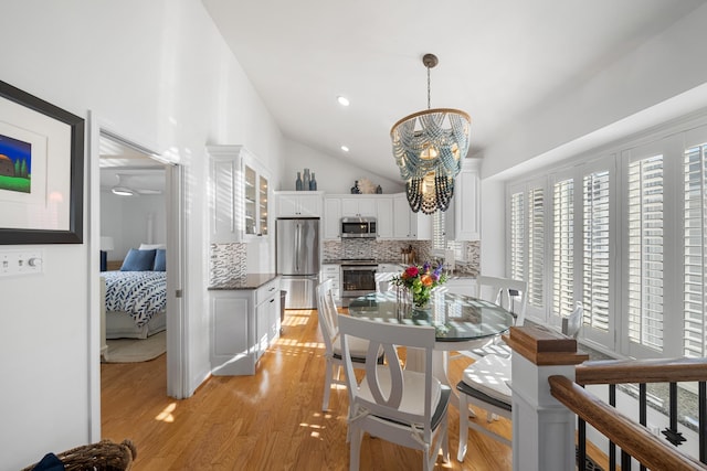 260 83rd St Unit 1, Stone Harbor, NJ 08247 - dining room with vaulted ceiling, a chandelier, and light wood-style floors