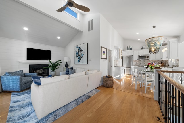 260 83rd St Unit 1, Stone Harbor, NJ 08247 - living room with ceiling fan, light wood-type flooring, a fireplace, recessed lighting, and a chandelier