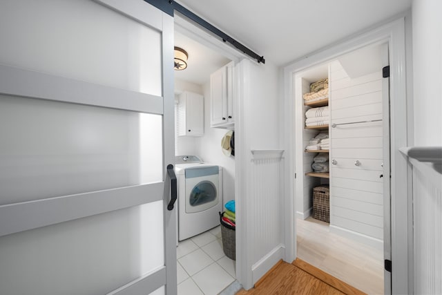 260 83rd St Unit 1, Stone Harbor, NJ 08247 - laundry area with washer / dryer, cabinet space, and light wood finished floors