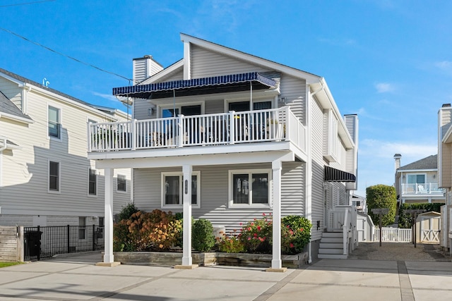 260 83rd St Unit 1, Stone Harbor, NJ 08247 - view of front of property with a balcony, a chimney, fence, a storage shed, and an outdoor structure