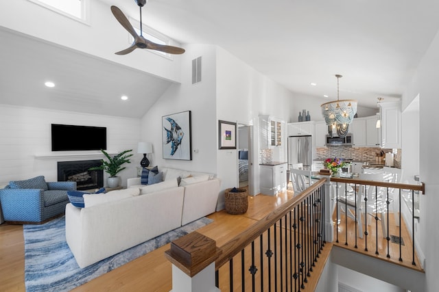 260 83rd St Unit 1, Stone Harbor, NJ 08247 - living room with a fireplace, light wood-style floors, ceiling fan, a chandelier, and recessed lighting