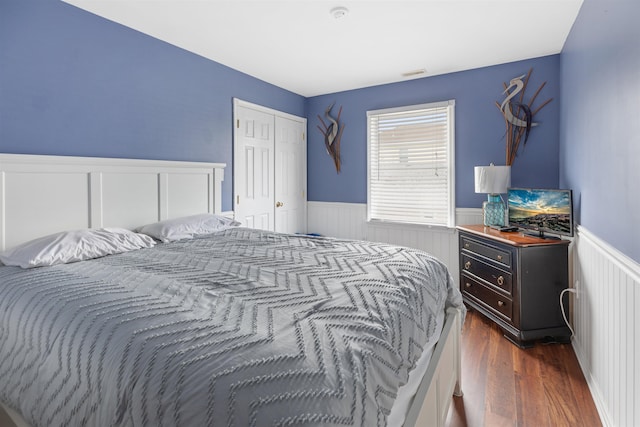 bedroom featuring dark hardwood / wood-style floors and a closet