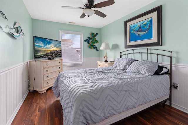 bedroom with ceiling fan and dark hardwood / wood-style flooring