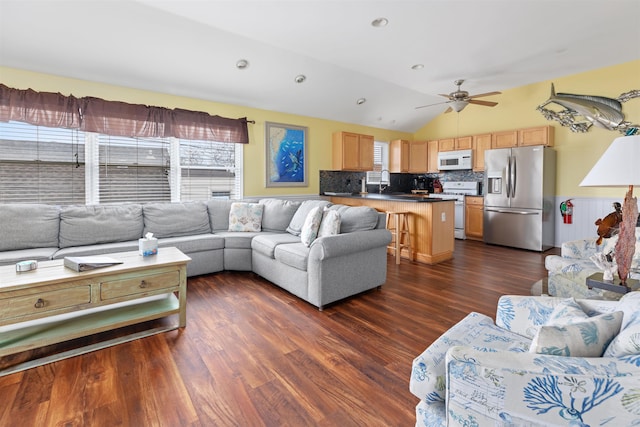 living room featuring ceiling fan, lofted ceiling, dark hardwood / wood-style floors, and a wealth of natural light