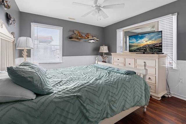 bedroom with ceiling fan and dark hardwood / wood-style flooring