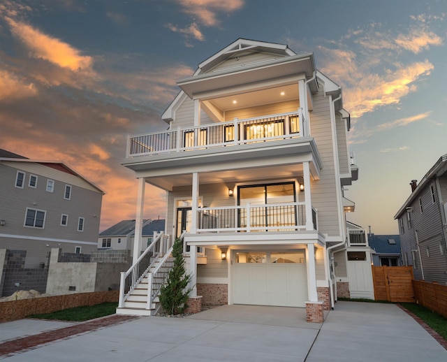 615 W Spruce Ave, North Wildwood, NJ 08260 - raised beach house featuring a balcony, driveway, stairs, a garage, and fence