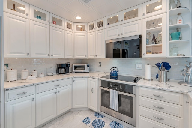 902 Ocean Dr Unit 302, Lower Township, NJ 08204 - kitchen featuring stainless steel appliances, white cabinets, backsplash, light marble finish floors, and recessed lighting