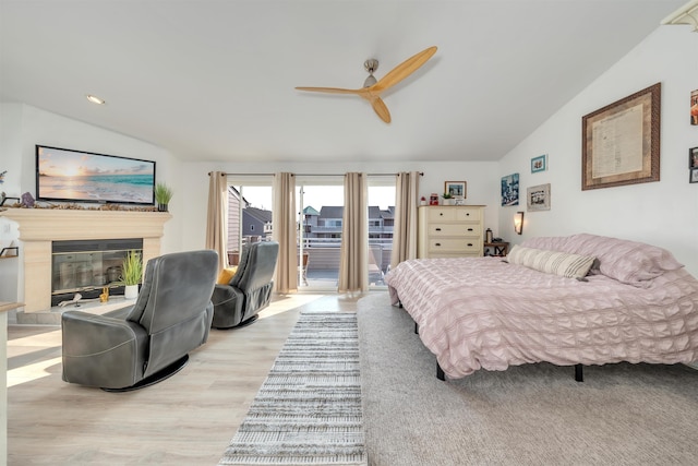902 Ocean Dr Unit 302, Lower Township, NJ 08204 - bedroom with lofted ceiling, access to exterior, wood finished floors, a glass covered fireplace, and a ceiling fan