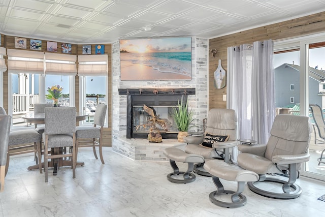 902 Ocean Dr Unit 302, Lower Township, NJ 08204 - living room featuring an ornate ceiling, plenty of natural light, wood walls, and a fireplace