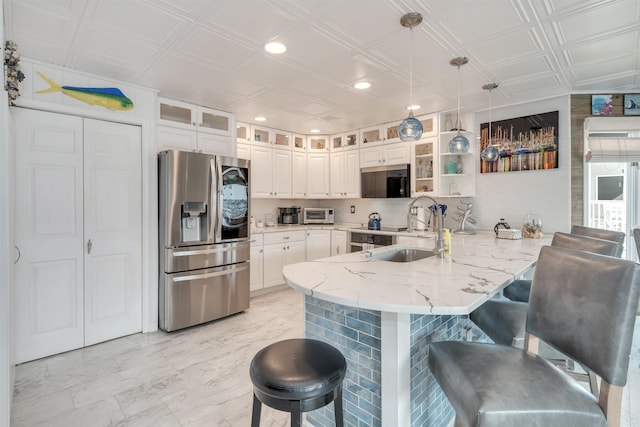 902 Ocean Dr Unit 302, Lower Township, NJ 08204 - kitchen with appliances with stainless steel finishes, a peninsula, a sink, a kitchen breakfast bar, and an ornate ceiling