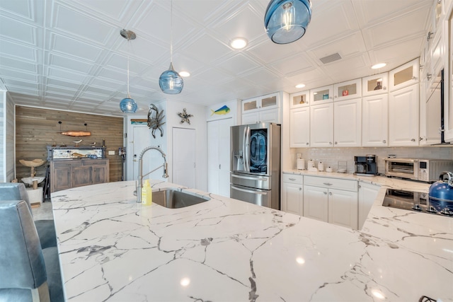 902 Ocean Dr Unit 302, Lower Township, NJ 08204 - kitchen featuring stainless steel refrigerator with ice dispenser, a sink, white cabinets, tasteful backsplash, and decorative light fixtures