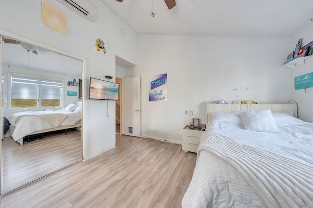 902 Ocean Dr Unit 302, Lower Township, NJ 08204 - bedroom featuring a wall mounted AC, light wood finished floors, and ceiling fan