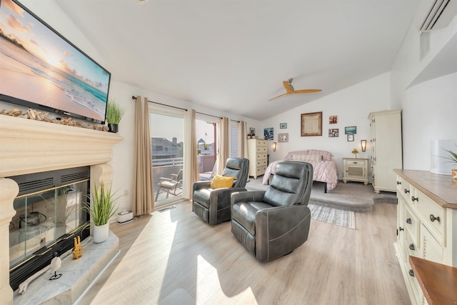 902 Ocean Dr Unit 302, Lower Township, NJ 08204 - living area with lofted ceiling, an AC wall unit, light wood finished floors, a glass covered fireplace, and ceiling fan
