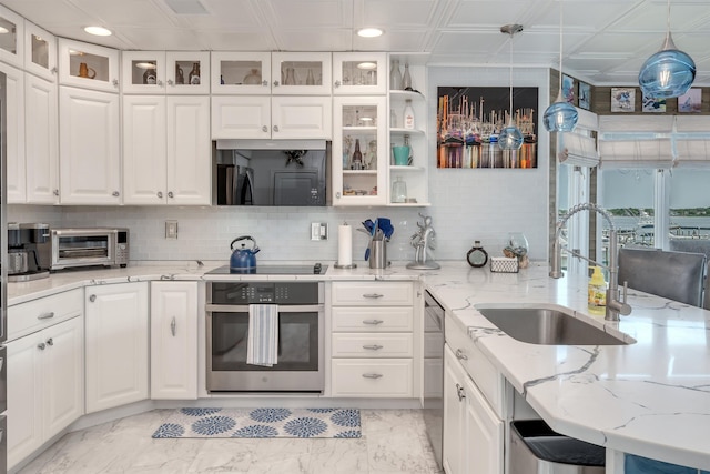 902 Ocean Dr Unit 302, Lower Township, NJ 08204 - kitchen with appliances with stainless steel finishes, light marble finish floors, white cabinetry, a sink, and recessed lighting