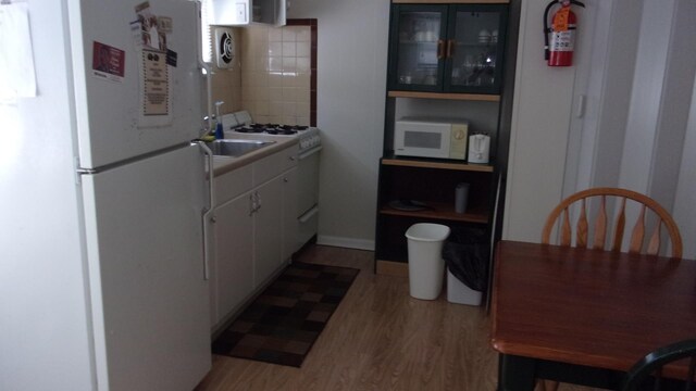 309 E Topeka Ave, Wildwood Crest, NJ 08260 - kitchen with backsplash, white cabinets, white appliances, and light wood-type flooring