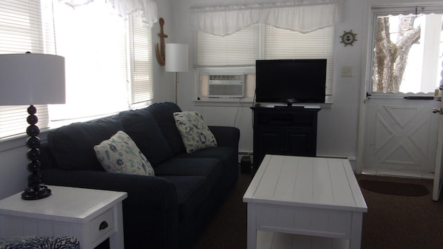 living room featuring dark colored carpet and cooling unit