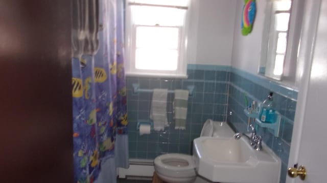 309 E Topeka Ave, Wildwood Crest, NJ 08260 - bathroom with a baseboard radiator, toilet, tile walls, and sink