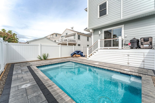 view of pool featuring a wooden deck and a patio