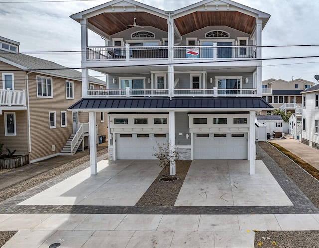 coastal inspired home featuring a balcony and a garage