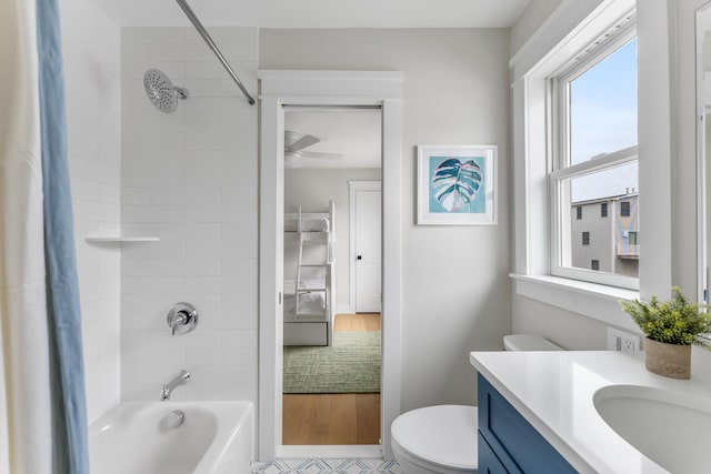 full bathroom with toilet, tiled shower / bath combo, and vanity