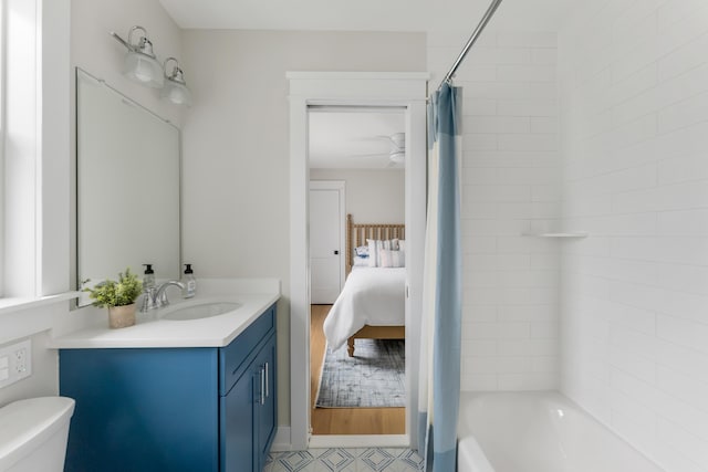 full bathroom featuring shower / bath combination with curtain, vanity, and toilet