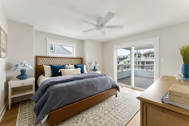 bedroom featuring multiple windows, access to exterior, ceiling fan, and light hardwood / wood-style flooring