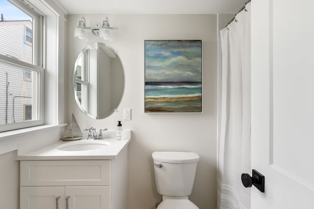 bathroom with toilet and vanity