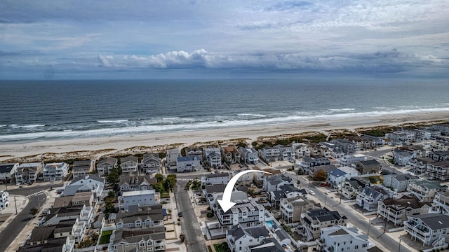 bird's eye view featuring a beach view and a water view