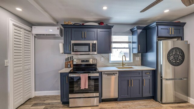 5407 Pacific Ave Unit 13, Wildwood Crest, NJ 08260 - kitchen featuring appliances with stainless steel finishes, an AC wall unit, light countertops, decorative backsplash, and light wood finished floors