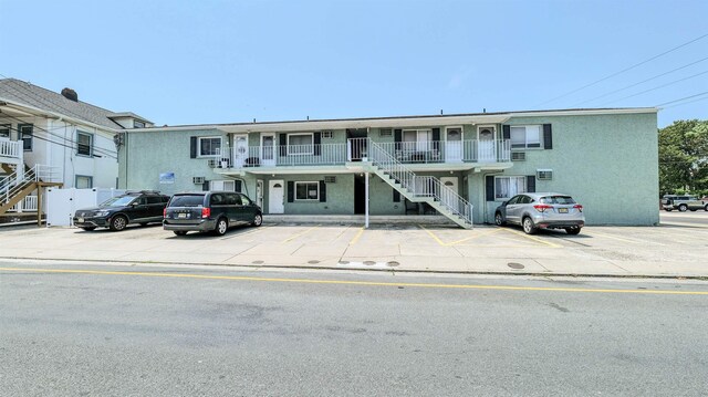 5407 Pacific Ave Unit 13, Wildwood Crest, NJ 08260 - view of front of property with stairs, uncovered parking, stucco siding, and covered porch