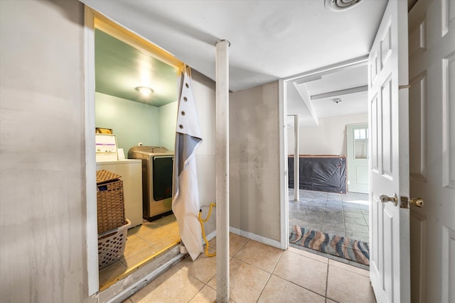 bathroom with tile patterned floors, washing machine and dryer, and baseboards