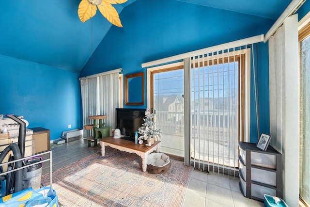 living area featuring lofted ceiling, tile patterned floors, and ceiling fan