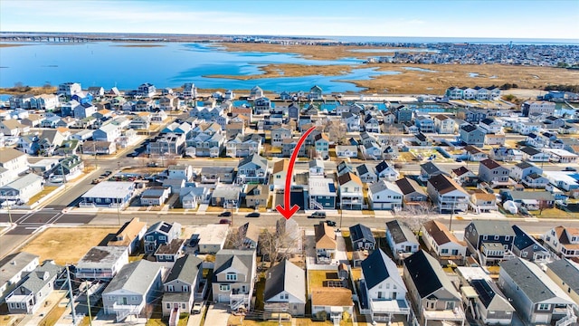 drone / aerial view with a residential view and a water view