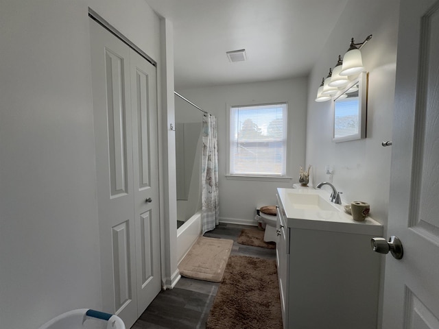 bathroom featuring toilet, wood finished floors, vanity, visible vents, and shower / bath combo with shower curtain