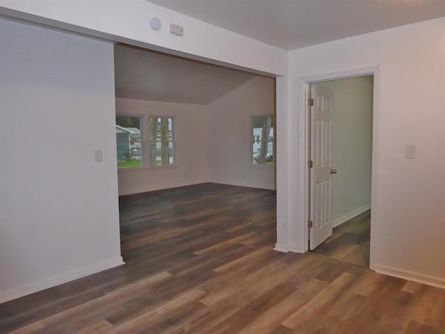 unfurnished room featuring baseboards and wood finished floors