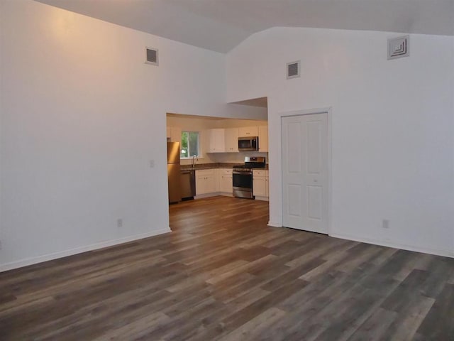 unfurnished living room with high vaulted ceiling, baseboards, visible vents, and dark wood-style flooring