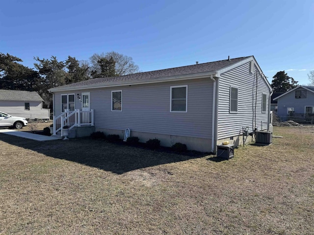 view of front of house featuring crawl space, a front yard, fence, and central air condition unit