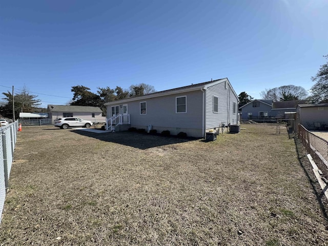 manufactured / mobile home with crawl space, a front lawn, fence, and central AC unit